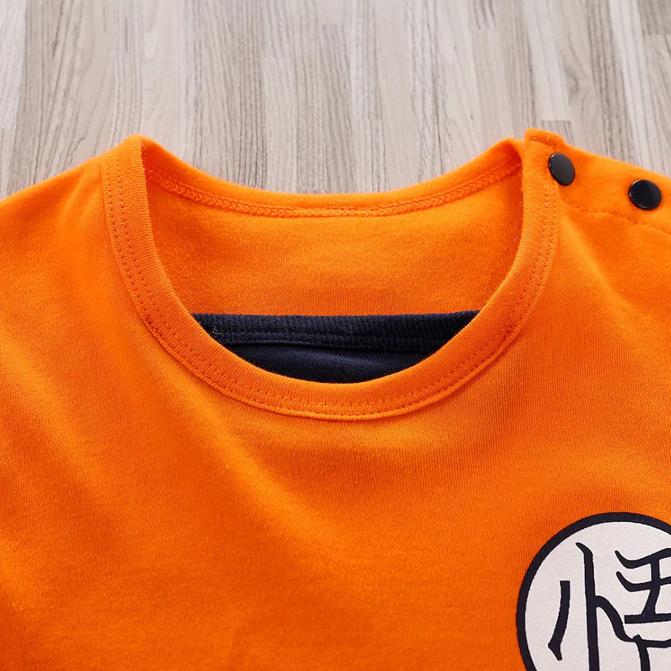 Baby anime romper back view in orange and black with character logo