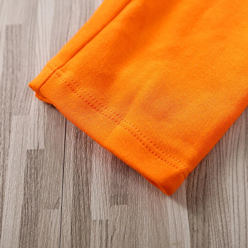 Baby anime romper orange fabric detail showing smooth texture
