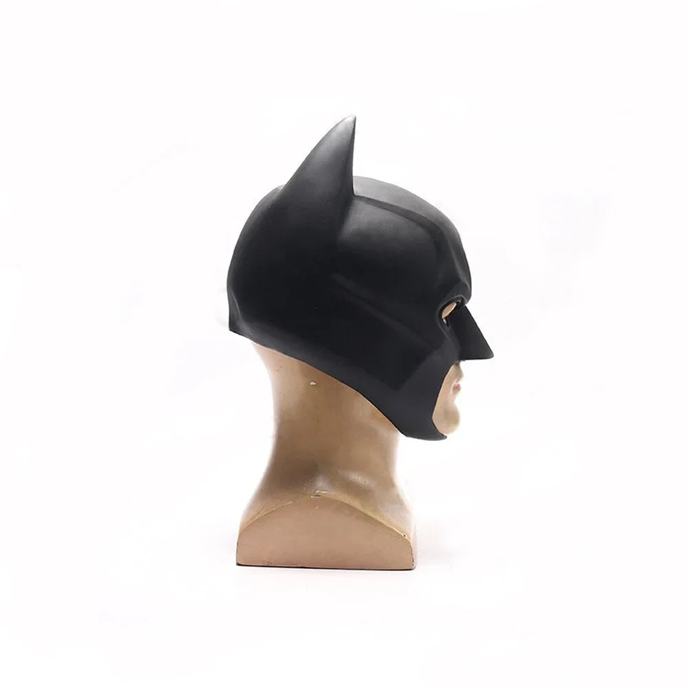 Batman latex mask in black, side view showing pointed ears and smooth surface